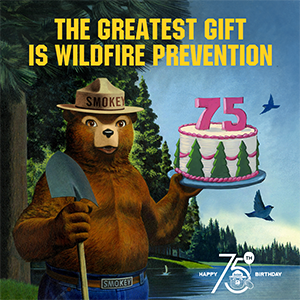 Smokey Bear Holds 75th birthday cake